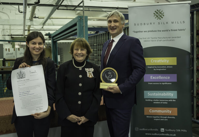 Emma Collings and Julius Walters posing with Lady Clare whilst holding the ~King's Award trophy ands croll