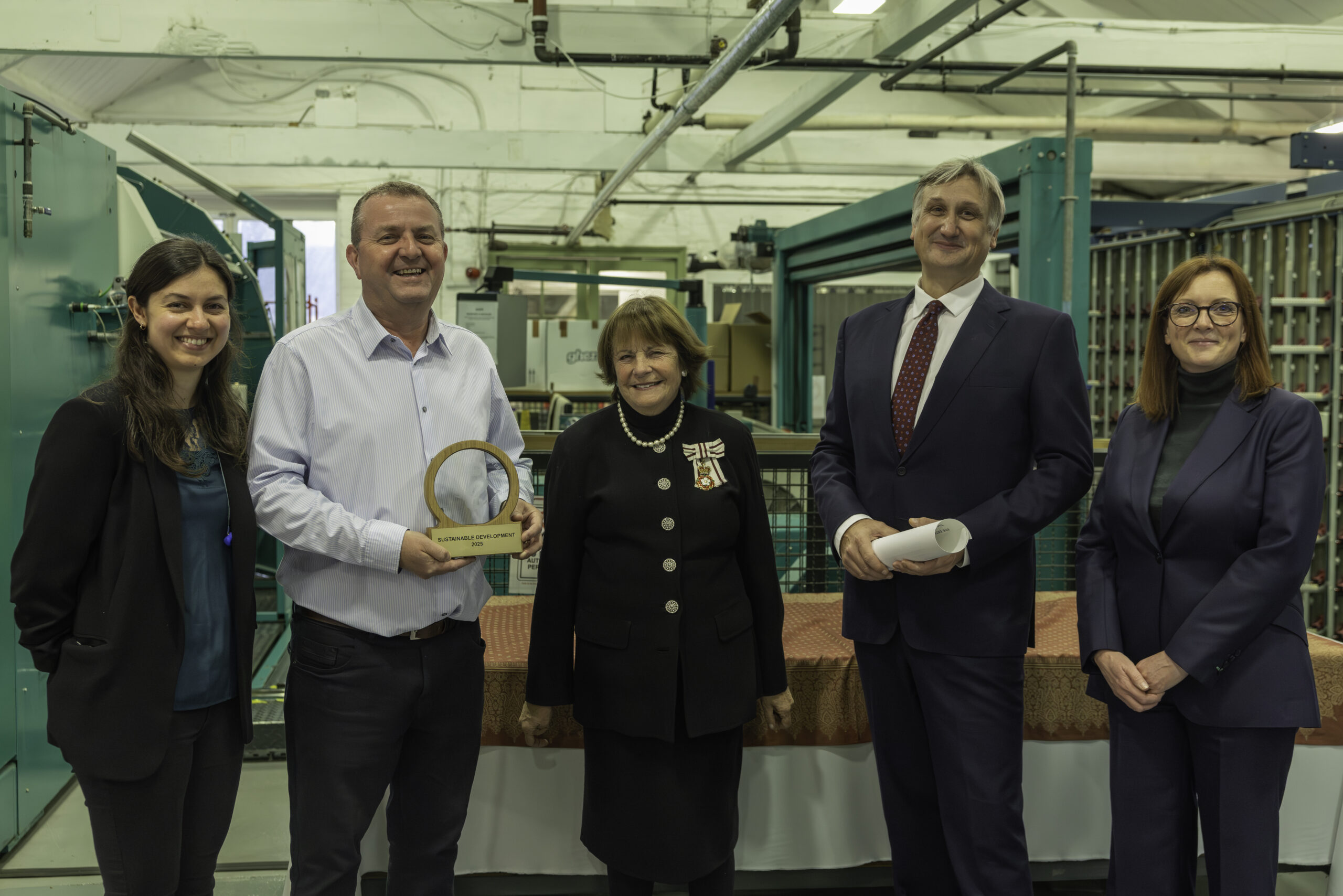 David Walters team members posing with award and Lady Clare