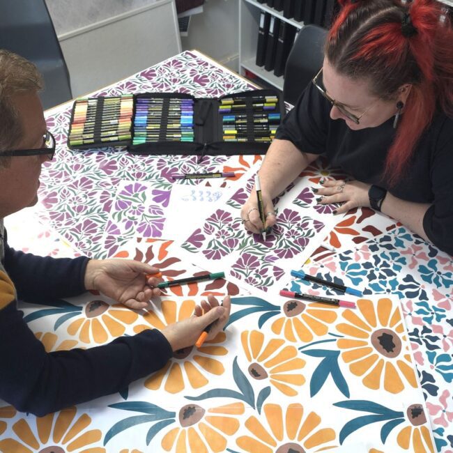 Sales and design working together on hand painted floral designs for proposte collection