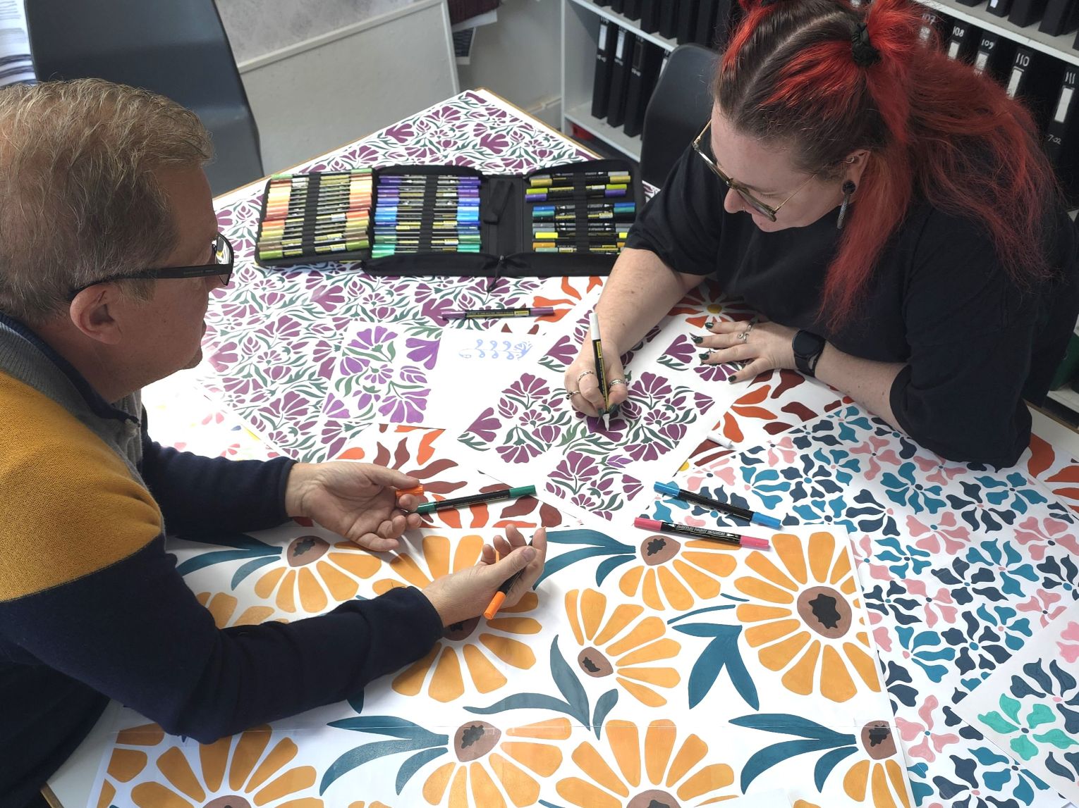 Sales and design working together on hand painted floral designs for proposte collection