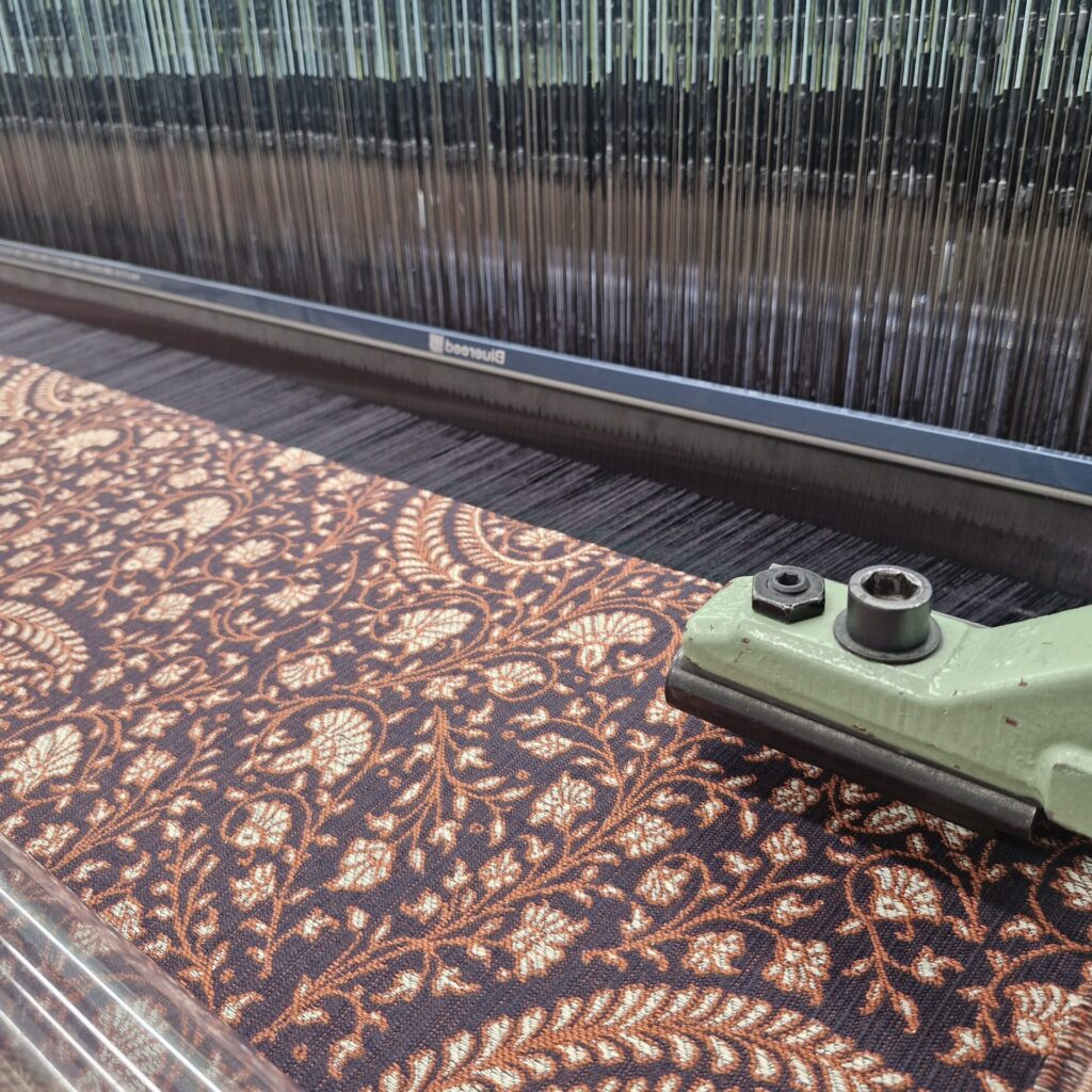 Paisley inspire woven jacquard fabric on loom