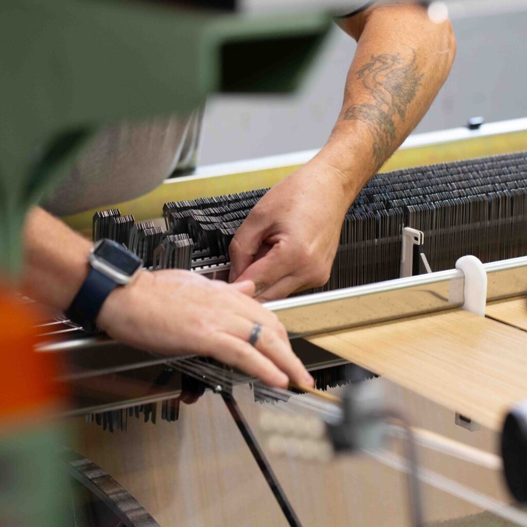 Mechanic setting up the loom before weaving